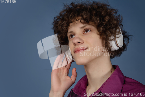 Image of Caucasian young man\'s portrait isolated on blue studio background with copyspace