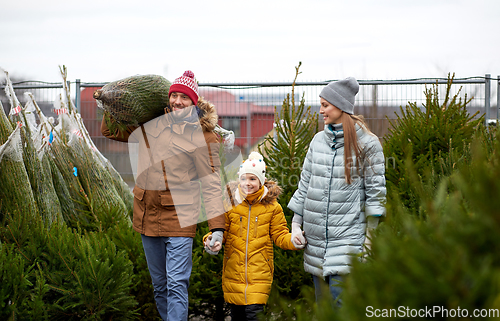 Image of happy family buying christmas tree at market