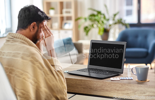 Image of sick indian man having video call on laptop