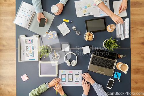Image of business team with gadgets working at office table
