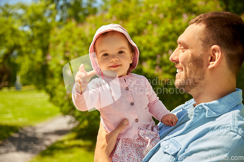 Image of happy father with baby daughter at summer park