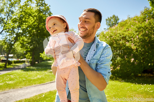 Image of happy father with baby daughter at summer park