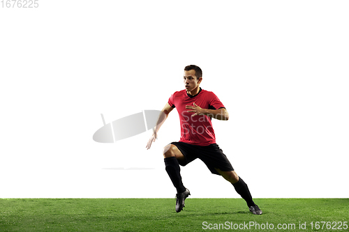 Image of Young football, soccer player of team in action, motion isolated on white background. Concept of sport, movement, energy and dynamic.