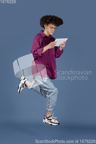 Image of Caucasian young man\'s portrait isolated on blue studio background with copyspace