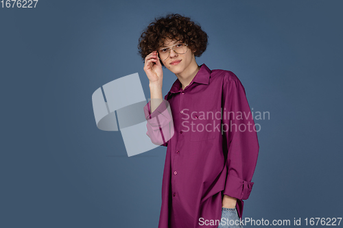 Image of Caucasian young man\'s portrait isolated on blue studio background with copyspace