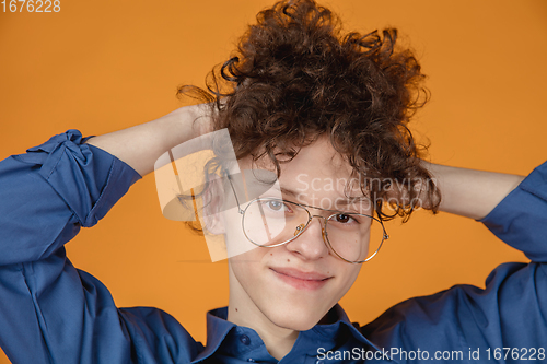 Image of Caucasian young man\'s portrait isolated on yellow studio background with copyspace