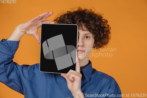 Image of Caucasian young man\'s portrait isolated on yellow studio background with copyspace