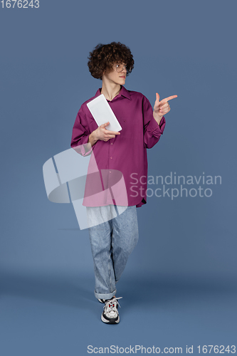 Image of Caucasian young man\'s portrait isolated on blue studio background with copyspace