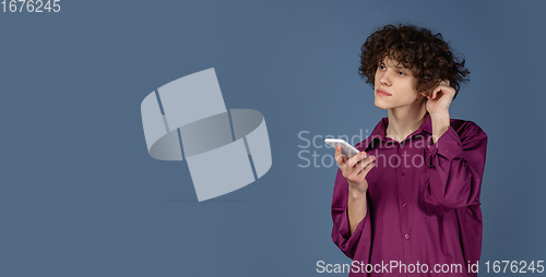 Image of Caucasian young man\'s portrait isolated on blue studio background with copyspace