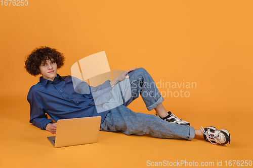 Image of Caucasian young man\'s portrait isolated on yellow studio background with copyspace