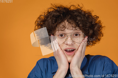 Image of Caucasian young man\'s portrait isolated on yellow studio background with copyspace