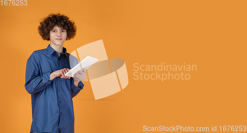 Image of Caucasian young man\'s portrait isolated on yellow studio background with copyspace