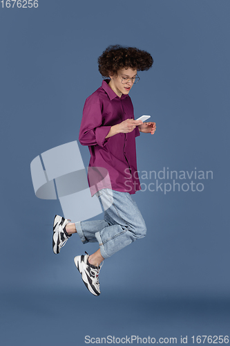 Image of Caucasian young man\'s portrait isolated on blue studio background with copyspace