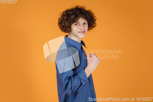 Image of Caucasian young man\'s portrait isolated on yellow studio background with copyspace