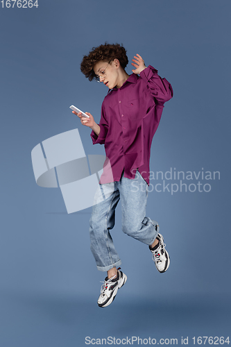 Image of Caucasian young man\'s portrait isolated on blue studio background with copyspace