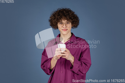 Image of Caucasian young man\'s portrait isolated on blue studio background with copyspace