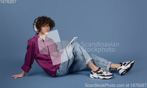 Image of Caucasian young man\'s portrait isolated on blue studio background with copyspace