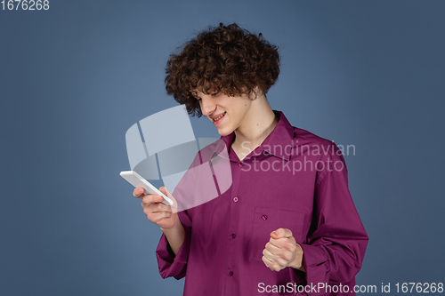 Image of Caucasian young man\'s portrait isolated on blue studio background with copyspace