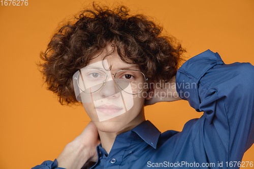 Image of Caucasian young man\'s portrait isolated on yellow studio background with copyspace