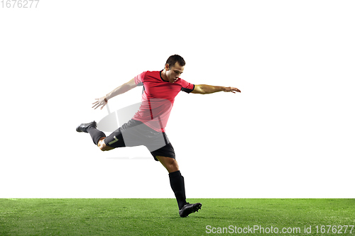 Image of Young football, soccer player of team in action, motion isolated on white background. Concept of sport, movement, energy and dynamic.