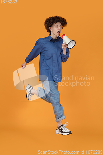 Image of Caucasian young man\'s portrait isolated on yellow studio background with copyspace