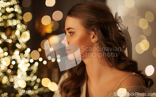 Image of portrait of young woman at home on christmas