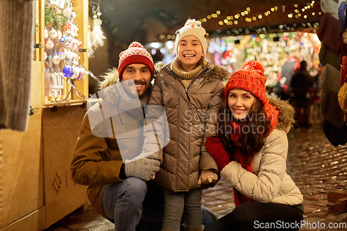 Image of happy family at christmas market in city