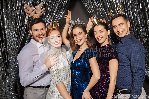 Image of happy friends posing at christmas party