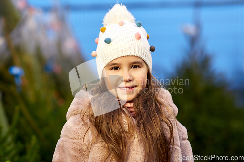 Image of portrait of little girl at christmas tree market