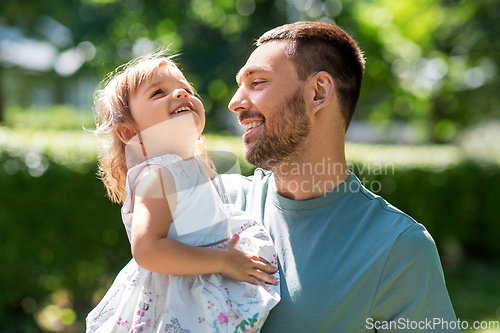 Image of happy father with baby daughter at summer park