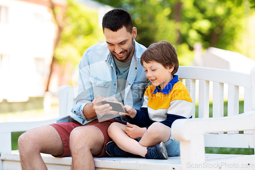 Image of father and son with smartphone at park