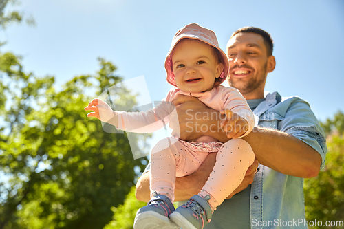 Image of happy father with baby daughter at summer park