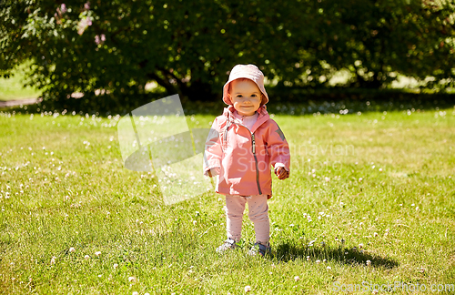 Image of happy little baby girl at park in summer