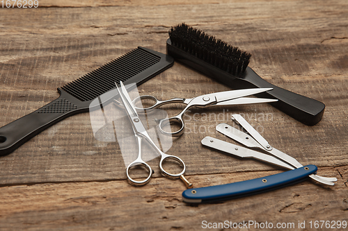 Image of Barber shop equipment set isolated on wooden table background.