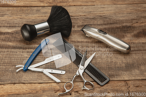 Image of Barber shop equipment set isolated on wooden table background.