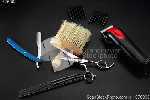 Image of Barber shop equipment set isolated on black table background.