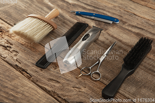 Image of Barber shop equipment set isolated on wooden table background.