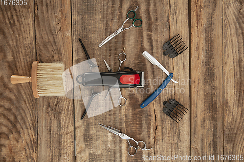 Image of Barber shop equipment set isolated on wooden table background.