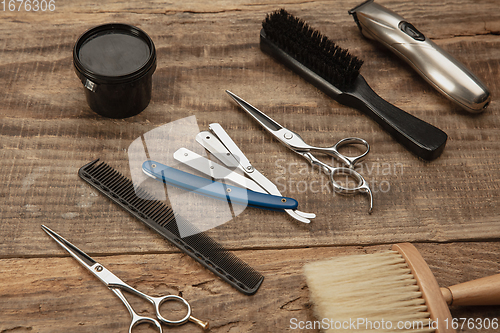 Image of Barber shop equipment set isolated on wooden table background.