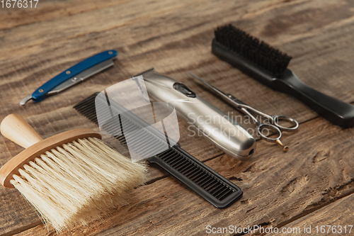 Image of Barber shop equipment set isolated on wooden table background.