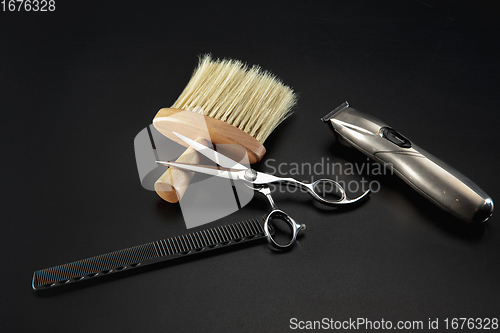 Image of Barber shop equipment set isolated on black table background.