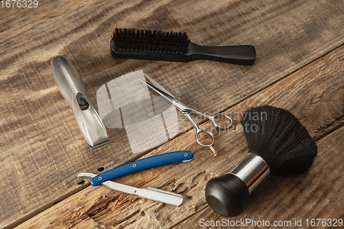 Image of Barber shop equipment set isolated on wooden table background.