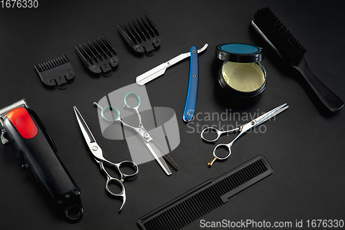 Image of Barber shop equipment set isolated on black table background.