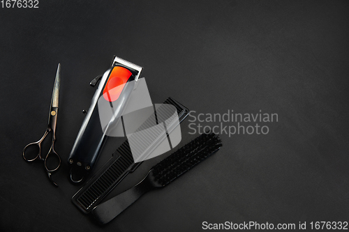 Image of Barber shop equipment set isolated on black table background.