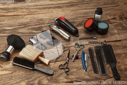 Image of Barber shop equipment set isolated on wooden table background.