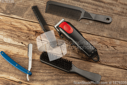 Image of Barber shop equipment set isolated on wooden table background.