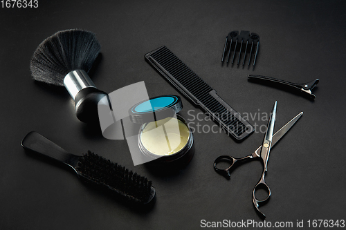 Image of Barber shop equipment set isolated on black table background.