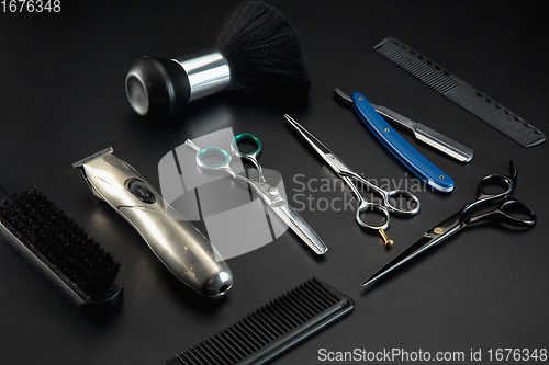 Image of Barber shop equipment set isolated on black table background.