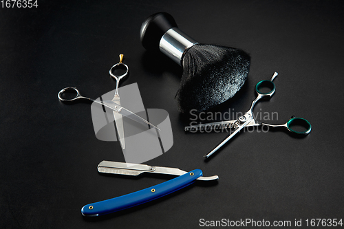 Image of Barber shop equipment set isolated on black table background.