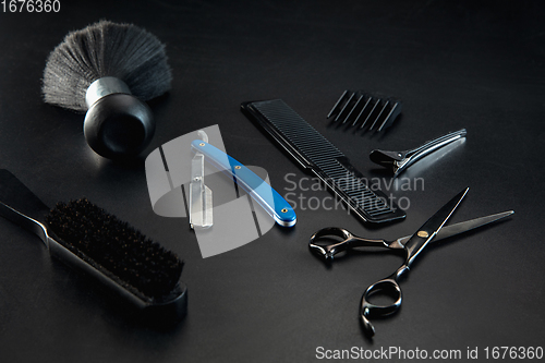 Image of Barber shop equipment set isolated on black table background.